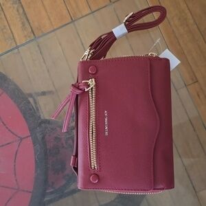 Delivering Joy multi-functioning crossbody and top handle bag